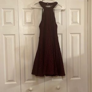 A purple/maroon mini dress with lace and glitter